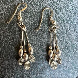 Dangly gold tone earrings.